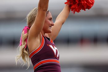 Oct 26, 2024; Blacksburg, Virginia, USA; A Virginia Tech Hokies cheerleader waves during a time out of the game between the Virginia Tech Hokies and the Georgia Tech Yellow Jackets at Lane Stadium. Mandatory Credit: Peter Casey-Imagn Images