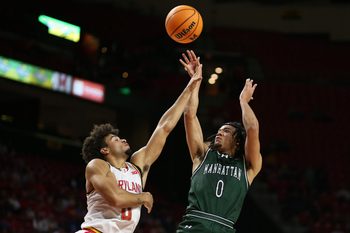 Nov 4, 2024; College Park, Maryland, USA; Manhattan Jaspers guard Devin Dinkins (0) shoots against Maryland Terrapins guard Ja'Kobi Gillespie (0) during the first half at Xfinity Center. Mandatory Credit: Daniel Kucin Jr.-Imagn Images
