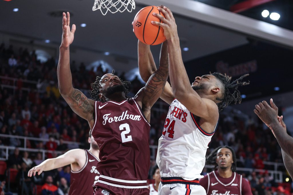Nov 4, 2024; Queens, New York, USA; Fordham Rams forward Romad Dean (2) and St. John's Red Storm forward Zuby Ejiofor (24) fight for a rebound in the second half at Carnesecca Arena. Mandatory Credit: Wendell Cruz-Imagn Images