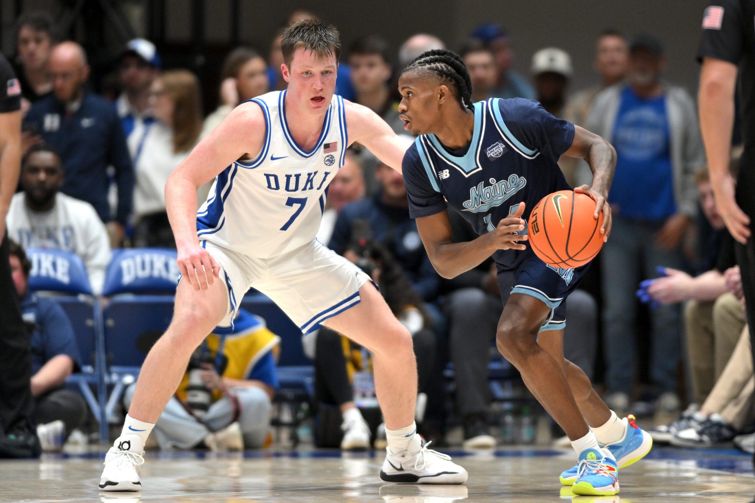 Nov 4, 2024; Durham, North Carolina, USA; Maine Black Bears guard AJ Lopez (14) fakes a drive down the baseline past Duke Blue Devils guard Kon Knueppel (7) during the second half at Cameron Indoor Stadium. Mandatory Credit: Zachary Taft-Imagn Images