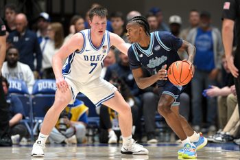 Nov 4, 2024; Durham, North Carolina, USA; Maine Black Bears guard AJ Lopez (14) fakes a drive down the baseline past Duke Blue Devils guard Kon Knueppel (7) during the second half at Cameron Indoor Stadium. Mandatory Credit: Zachary Taft-Imagn Images