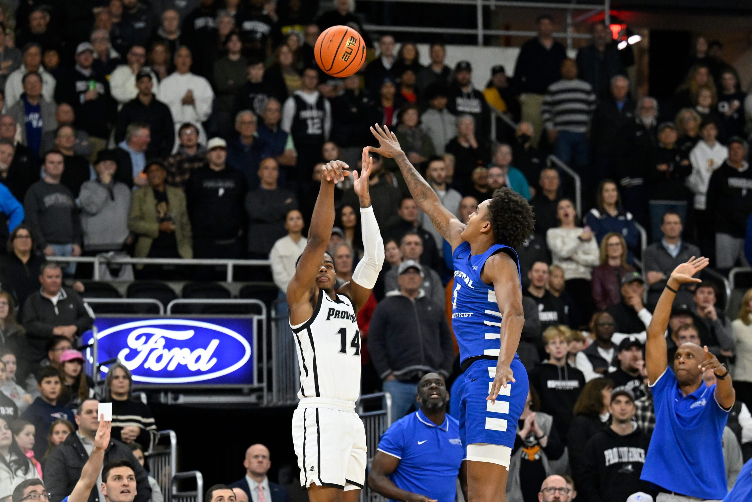 Nov 4, 2024; Providence, Rhode Island, USA; Providence Friars guard Corey Floyd Jr. (14) shoots over Central Connecticut State Blue Devils forward Darin Smith Jr. (5) at Amica Mutual Pavilion. Mandatory Credit: Eric Canha-Imagn Images