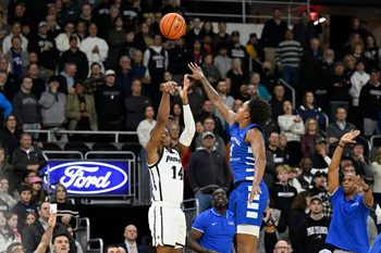 Nov 4, 2024; Providence, Rhode Island, USA; Providence Friars guard Corey Floyd Jr. (14) shoots over Central Connecticut State Blue Devils forward Darin Smith Jr. (5) at Amica Mutual Pavilion. Mandatory Credit: Eric Canha-Imagn Images