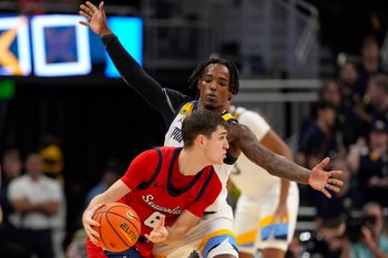 Nov 4, 2024; Milwaukee, Wisconsin, USA;  Marquette Golden Eagles guard Tre Norman (5) defends Stony Brook Seawolves guard Jared Frey (6) during the second half at Fiserv Forum. Mandatory Credit: Jeff Hanisch-Imagn Images