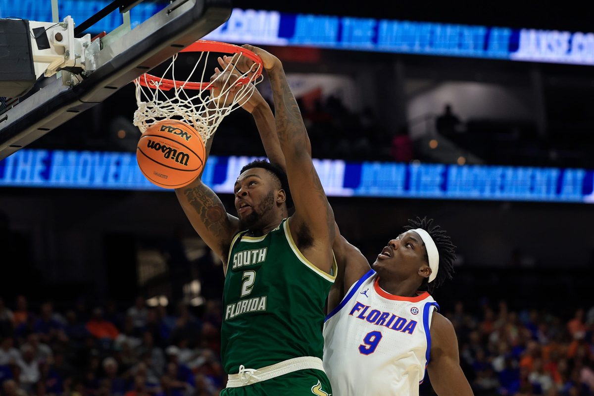 South Florida Bulls forward Jamille Reynolds (2) dunks on Florida Gators center Rueben Chinyelu (9) during the second half of an NCAA men’s basketball matchup Monday, Nov. 4, 2024 at VyStar Veterans Memorial Arena in Jacksonville, Fla. Florida defeated South Florida 98-83. [Corey Perrine/Florida Times-Union]