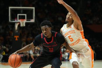 Gardner-Webb guard Darryl Simmons II (8) tries to get to the basket while defended by Tennessee guard Zakai Zeigler (5) during an NCAA college basketball game on Monday, Nov. 4, 2024, in Knoxville, Tenn.