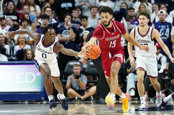 Nov 6, 2024; Storrs, Connecticut, USA;Connecticut Huskies guard Ahmad Nowell (0) and Sacred Heart Pioneers forward Raymond Espinal-Guzman (15) work for the ball in the second half at Harry A. Gampel Pavilion. Mandatory Credit: David Butler II-Imagn Images