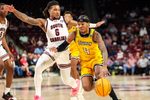Nov 12, 2024; Columbia, South Carolina, USA; Towson Tigers guard Dylan Williamson (4) drives past South Carolina Gamecocks guard Jamarii Thomas (6) in the second half at Colonial Life Arena. Mandatory Credit: Jeff Blake-Imagn Images