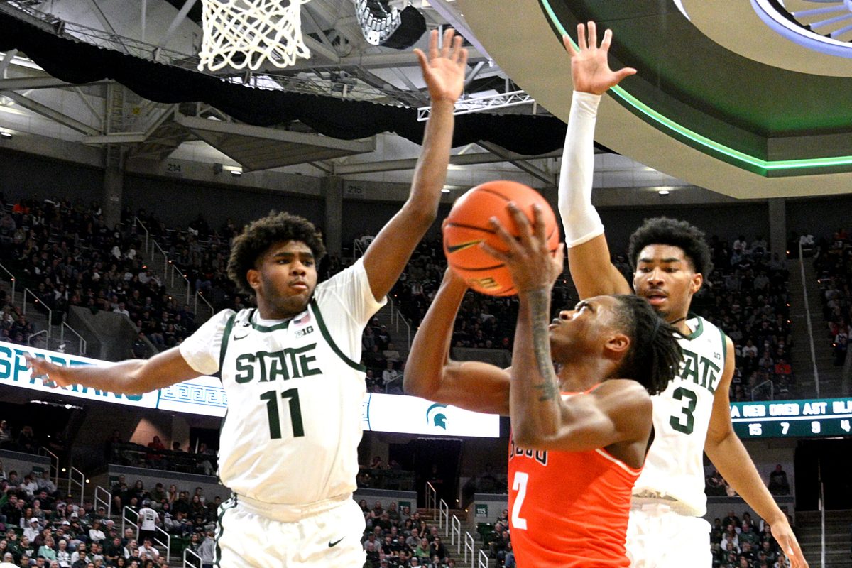 Nov 16, 2024; East Lansing, Michigan, USA;  Bowling Green Falcons guard Javontae Campbell (2) gets stopped by Michigan State Spartans guards Jase Richardson (11) and Jaden Akins (3) during the first half at Jack Breslin Student Events Center. Mandatory Credit: Dale Young-Imagn Images