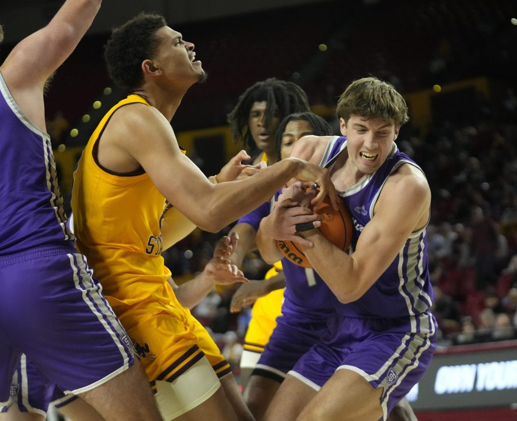 St. Thomas guard Nolan Minessale (4) strips the ball from Arizona State forward Basheer Jihad (8) during the first half at Desert Financial Arena on Sunday, Nov. 17, 2024.