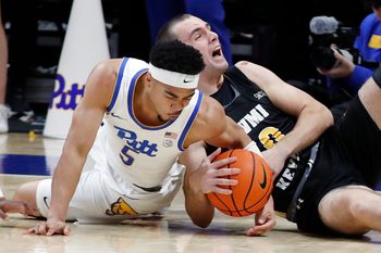 Nov 18, 2024; Pittsburgh, Pennsylvania, USA;  Pittsburgh Panthers guard Ishmael Leggett (5) and Virginia Military Keydets forward Cal Liston (0) fight for the ball during the second half at the Petersen Events Center. Mandatory Credit: Charles LeClaire-Imagn Images