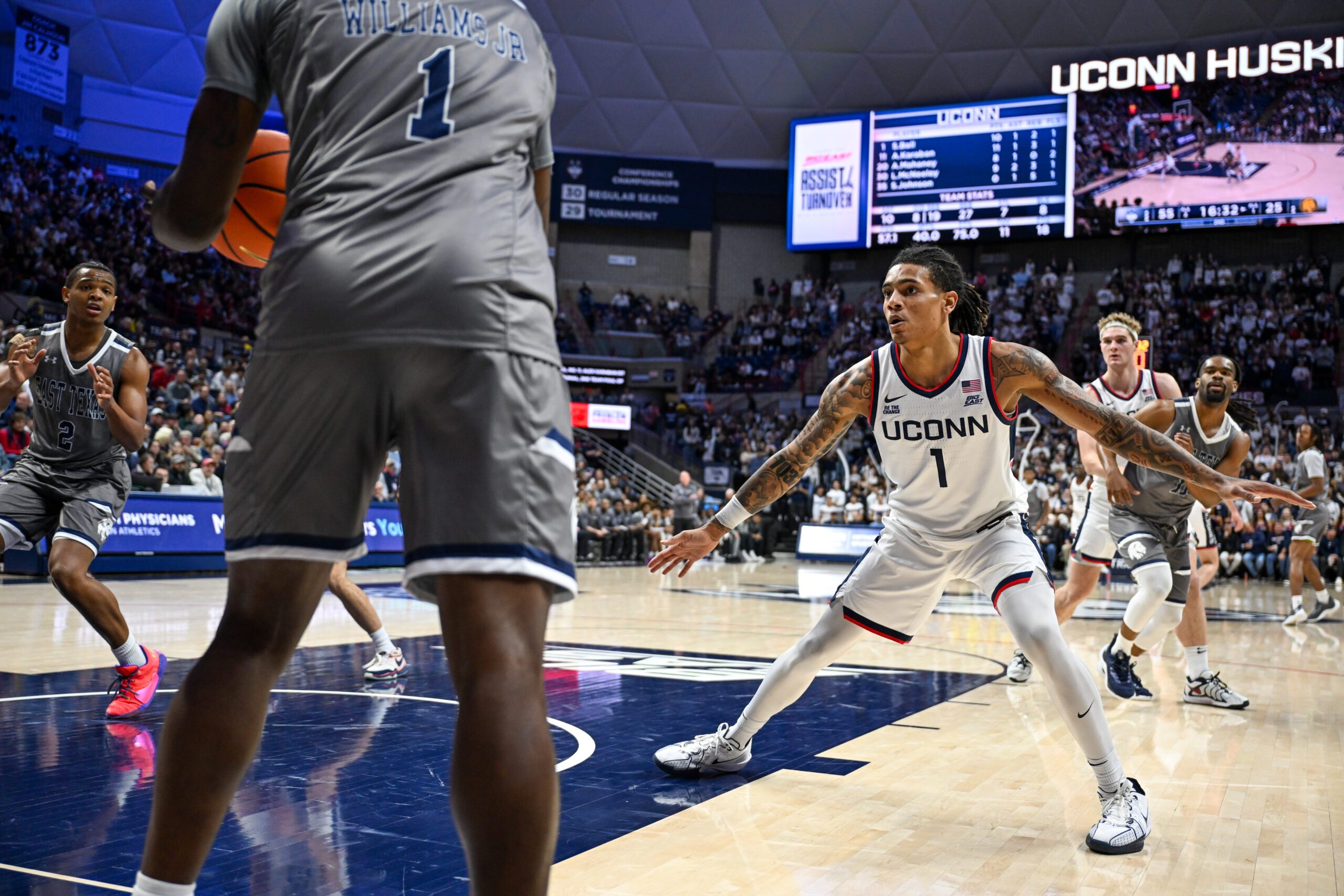 Nov 19, 2024; Storrs, Connecticut, USA; Connecticut Huskies guard Solo Ball (1) defends the inbound pass by Texas A&M Commerce guard Scooter Williams Jr. (1) during the second half at Harry A. Gampel Pavilion. Mandatory Credit: Mark Smith-Imagn Images