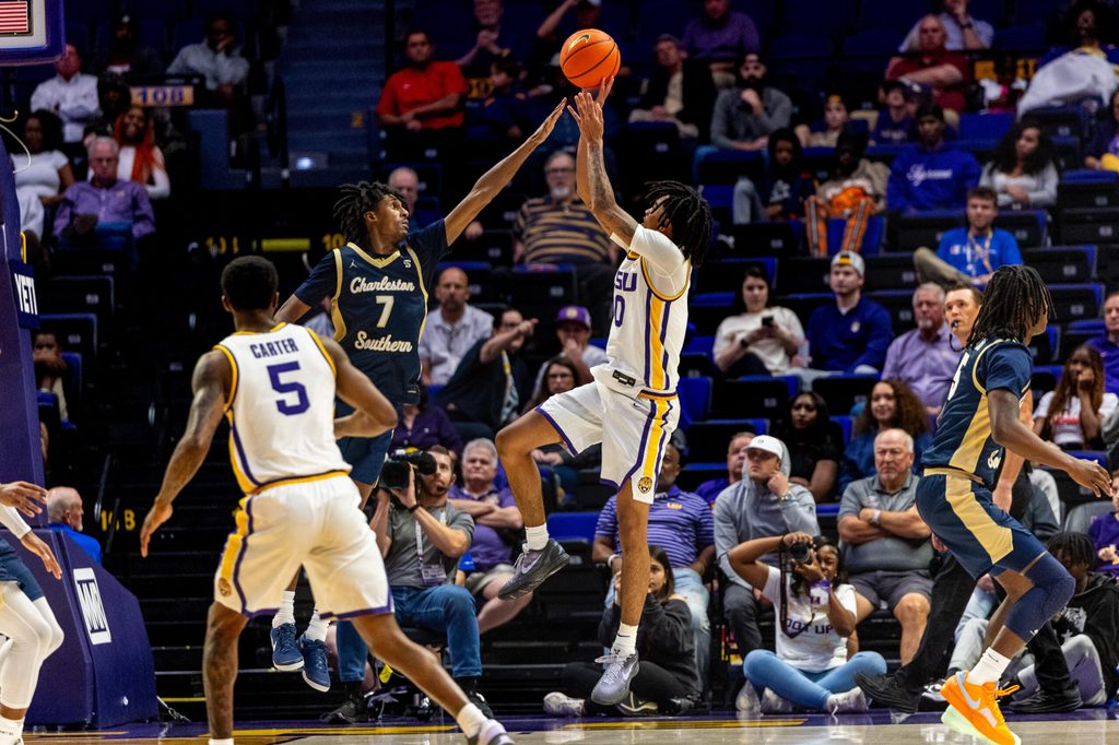 Nov 19, 2024; Baton Rouge, Louisiana, USA; LSU Tigers forward Daimion Collins (10) shoots a jump shot against Charleston Southern Buccaneers guard Daylen Berry (7) during the second half at Pete Maravich Assembly Center. Mandatory Credit: Stephen Lew-Imagn Images