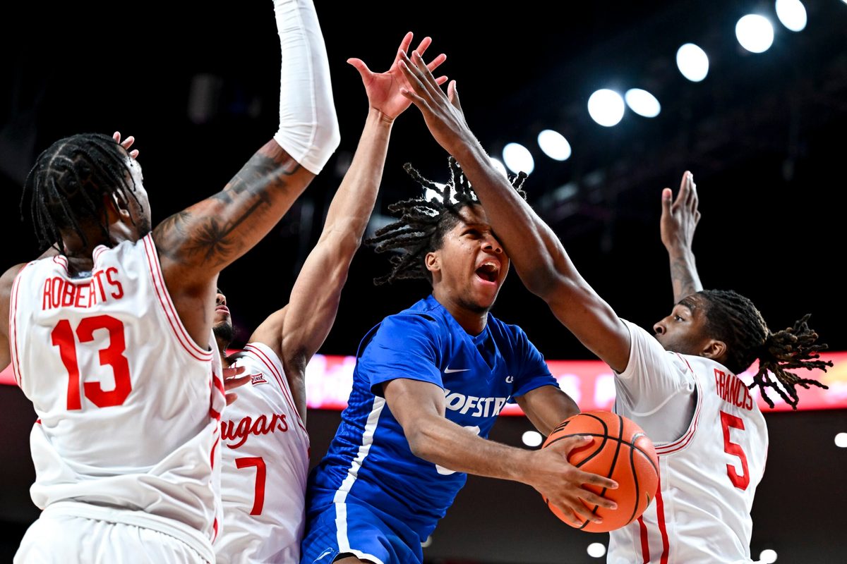 Nov 22, 2024; Houston, Texas, USA; Houston Cougars forward Ja'Vier Francis (5) fouls Hofstra Pride guard KiJan Robinson (0) during the first half at Fertitta Center. Mandatory Credit: Maria Lysaker-Imagn Images