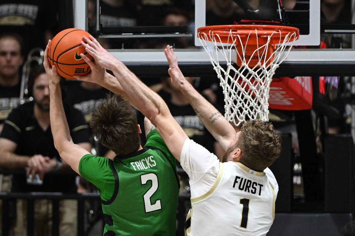 Nov 23, 2024; West Lafayette, Indiana, USA; Purdue Boilermakers forward Caleb Furst (1) blocks a shot by Marshall Thundering Herd forward Wyatt Fricks (2) during the second half at Mackey Arena. Mandatory Credit: Marc Lebryk-Imagn Images