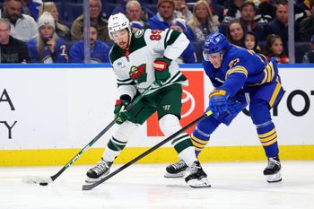 Nov 27, 2024; Buffalo, New York, USA;  Buffalo Sabres center Tage Thompson (72) tries to block a pass by Minnesota Wild center Frederick Gaudreau (89) during the third period at KeyBank Center. Mandatory Credit: Timothy T. Ludwig-Imagn Images