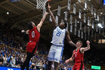 Nov 29, 2024; Durham, North Carolina, USA; Duke Blue Devils center Patrick Ngongba II (21) lays the ball up over Seattle Redhawks guard Brayden Maldonado (0) during the second half at Cameron Indoor Stadium. Mandatory Credit: Rob Kinnan-Imagn Images