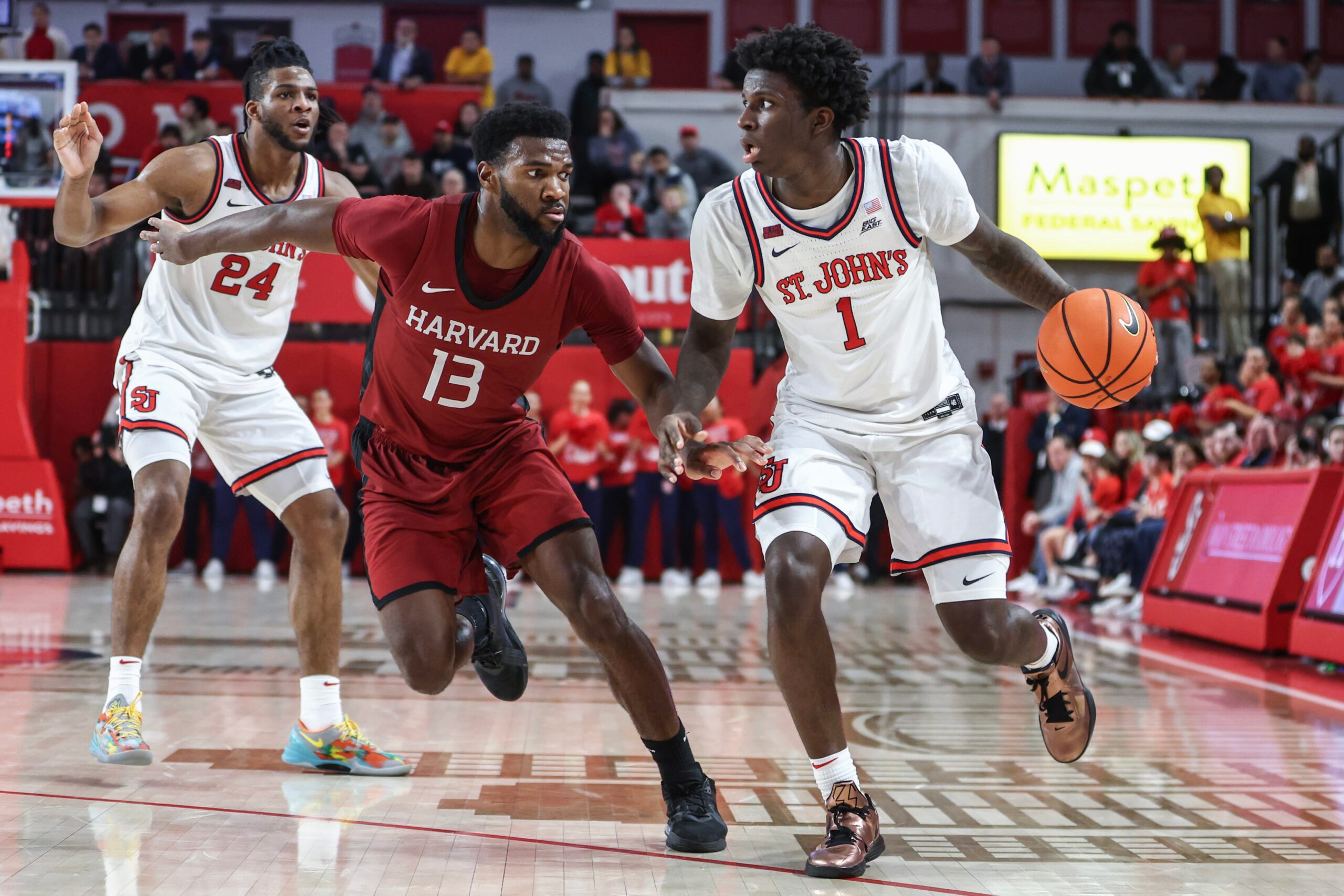 Nov 30, 2024; Queens, New York, USA;  St. John's Red Storm guard Kadary Richmond (1) looks to drive past Harvard Crimson guard Chandler Pigge (13) in the second half at Carnesecca Arena. Mandatory Credit: Wendell Cruz-Imagn Images