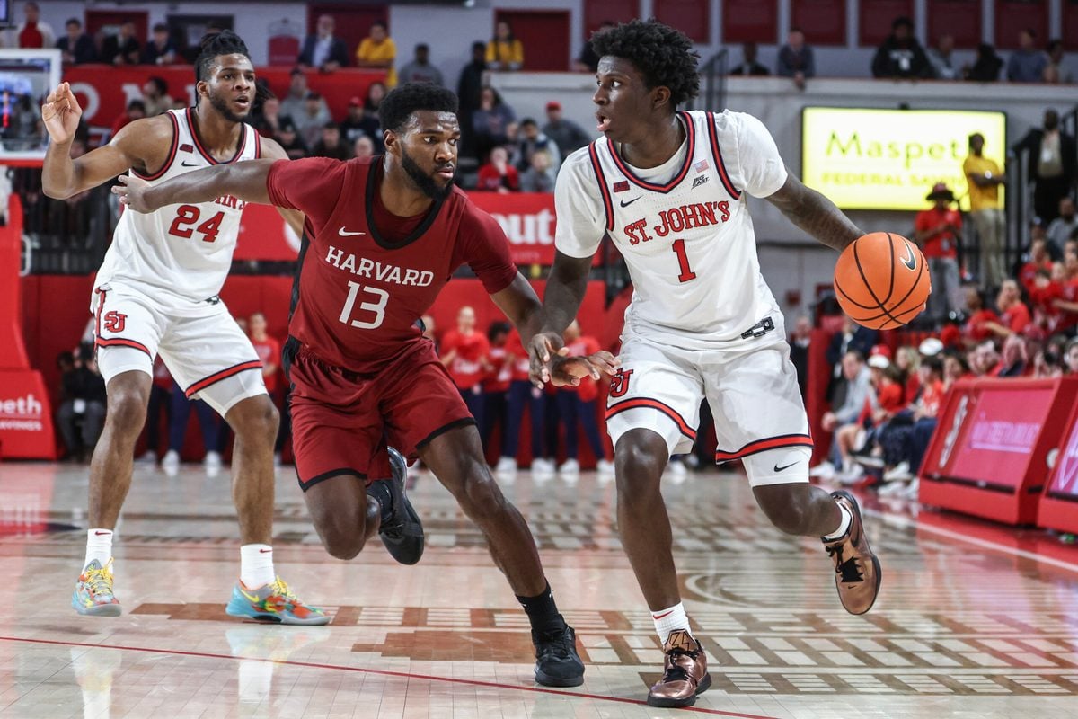 Nov 30, 2024; Queens, New York, USA; St. John's Red Storm guard Kadary Richmond (1) looks to drive past Harvard Crimson guard Chandler Pigge (13) in the second half at Carnesecca Arena. Mandatory Credit: Wendell Cruz-Imagn Images