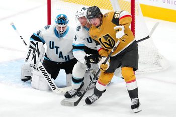 Nov 30, 2024; Las Vegas, Nevada, USA; Utah Hockey Club defenseman Juuso Valimaki (4) fends off Vegas Golden Knights right wing Alexander Holtz (26) as Utah Hockey Club goaltender Jaxson Stauber (33) defends his net during the third period at T-Mobile Arena. Mandatory Credit: Stephen R. Sylvanie-Imagn Images
