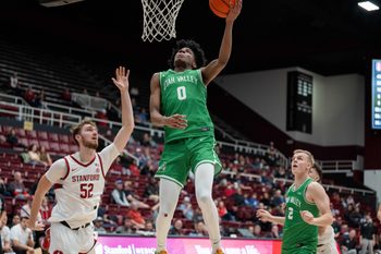 Dec 3, 2024; Stanford, California, USA; Utah Valley Wolverines guard Dominick Nelson (0) shoots a layup against Stanford Cardinal forward Aidan Cammann (52) during the second half at Maples Pavilion. Mandatory Credit: Neville E. Guard-Imagn Images