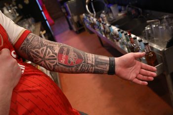 Owner Dan Zambito shows his deep love of the game of soccer tattooed on his arm at his newly opened Boot Room Pub at 198 Winton Road in Rochester Friday, Dec. 6, 2024.