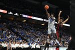 Dec 7, 2024; Omaha, Nebraska, USA;  Creighton Bluejays guard Jamiya Neal (5) scores against UNLV Rebels forward Jacob Bannarbie (12) in the second half at CHI Health Center Omaha. Mandatory Credit: Steven Branscombe-Imagn Images