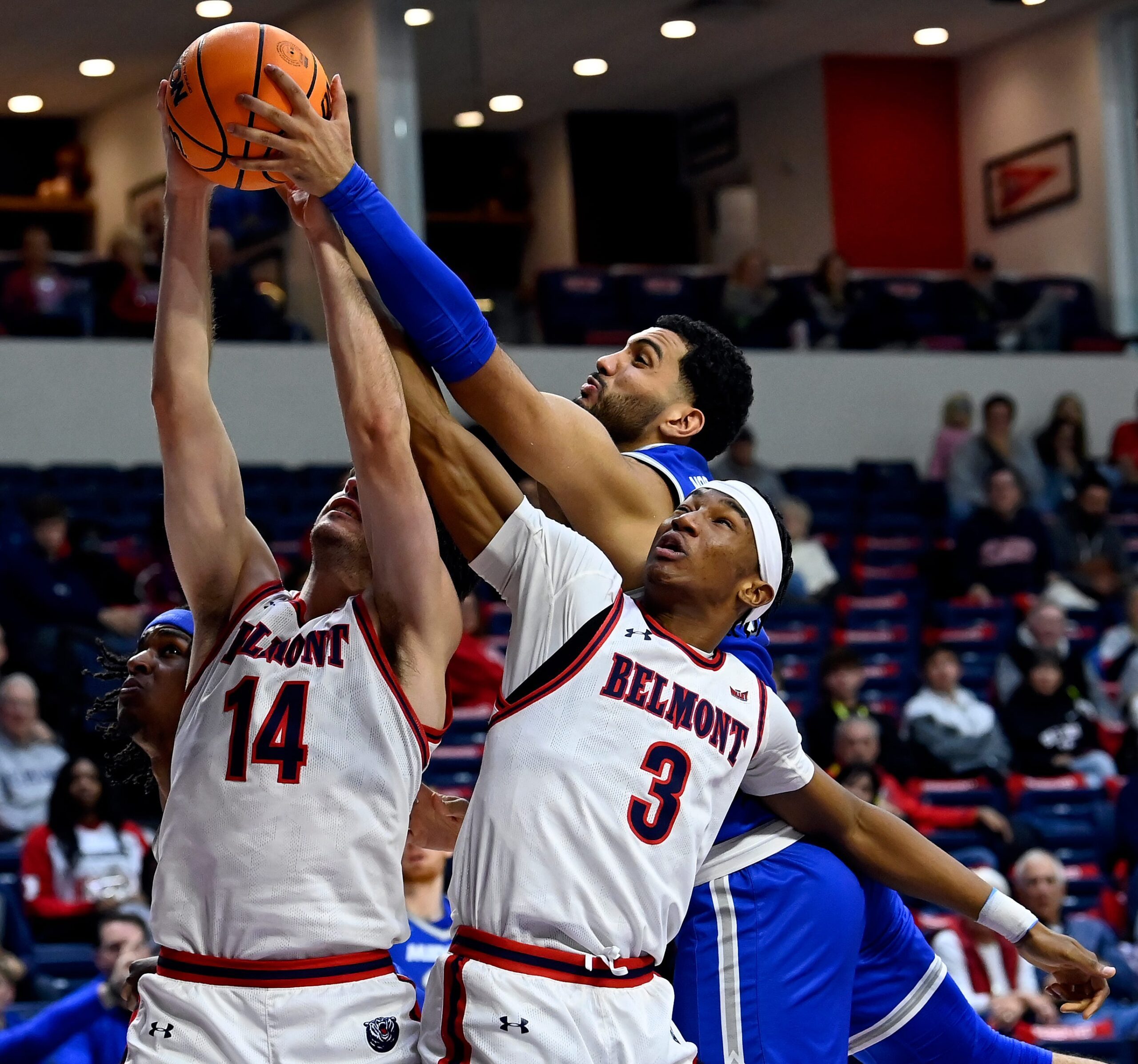 Belmont’s Sam Orme (14), Jonathan Pierre (3) and MTSU forward Essam Mostafa, right, go up for a rebound during an NCAA college basketball game Saturday, Dec. 7, 2024, in Nashville, Tenn.