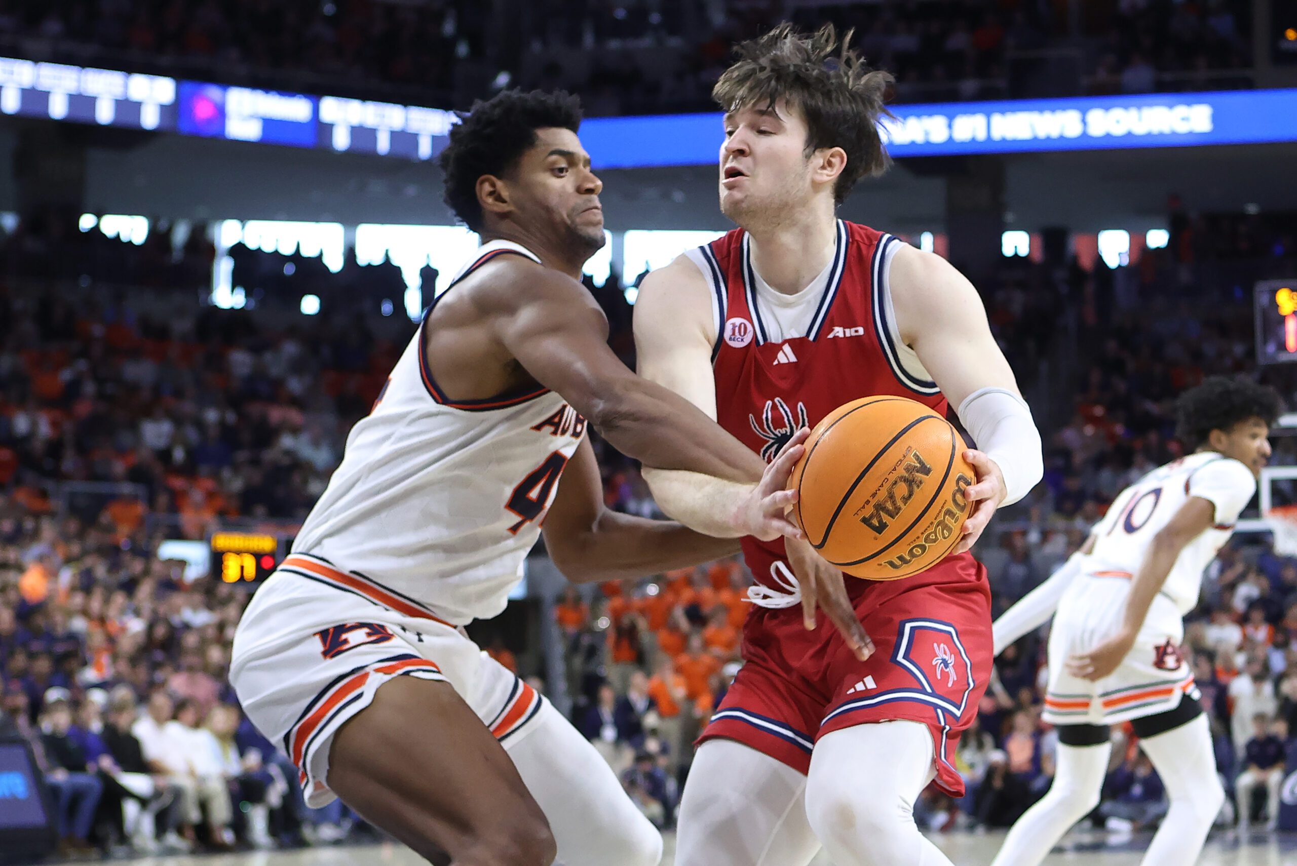 Dec 8, 2024; Auburn, Alabama, USA;  Richmond Spiders forward Jonathan Beagle (9) is fouled by Auburn Tigers center Dylan Cardwell (44) during the first half at Neville Arena. Mandatory Credit: John Reed-Imagn Images