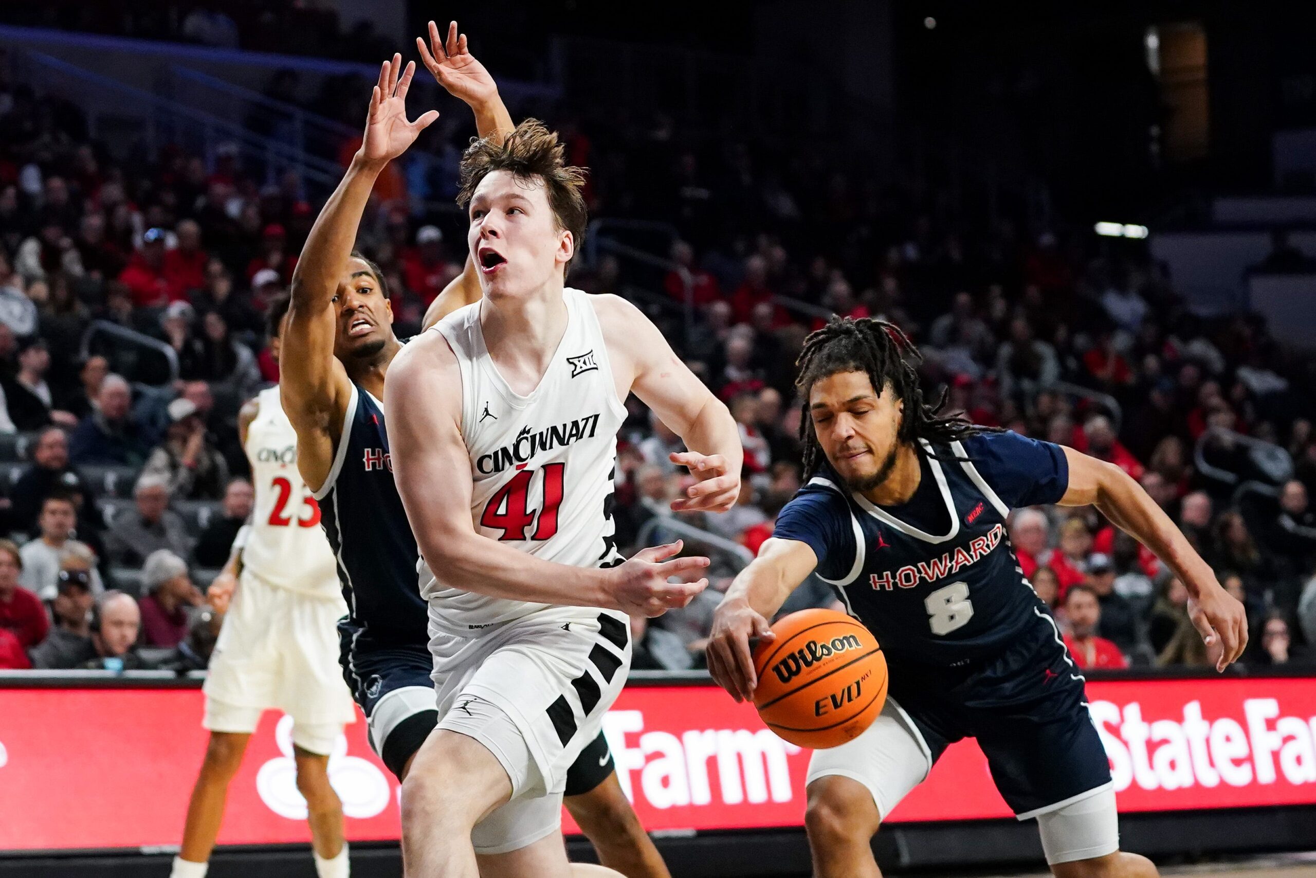 Howard Bison guard Joshua Strong (8) steals the ball from Cincinnati Bearcats guard Simas Lukosius (41) in the second half of a college basketball game between the Cincinnati Bearcats and Howard Bison, Sunday, Dec. 8, 2024, at Fifth Third Arena in Cincinnati. Bearcats won 84-67.