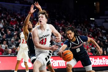 Howard Bison guard Joshua Strong (8) steals the ball from Cincinnati Bearcats guard Simas Lukosius (41) in the second half of a college basketball game between the Cincinnati Bearcats and Howard Bison, Sunday, Dec. 8, 2024, at Fifth Third Arena in Cincinnati. Bearcats won 84-67.