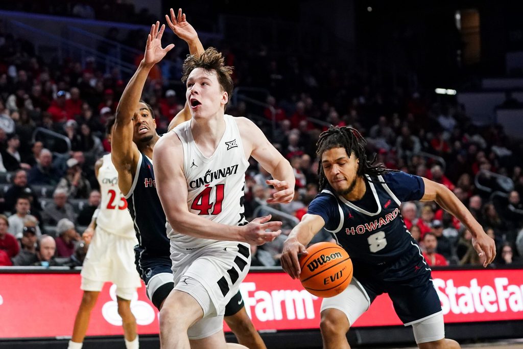 Howard Bison guard Joshua Strong (8) steals the ball from Cincinnati Bearcats guard Simas Lukosius (41) in the second half of a college basketball game between the Cincinnati Bearcats and Howard Bison, Sunday, Dec. 8, 2024, at Fifth Third Arena in Cincinnati. Bearcats won 84-67.