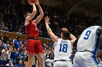 Dec 10, 2024; Durham, North Carolina, USA;  dIncarnate Word Cardinals forward Dylan Hayman (2) shoots over Duke Blue Devils forward Mason Gillis (18) during the first half at Cameron Indoor Stadium. Mandatory Credit: Rob Kinnan-Imagn Images