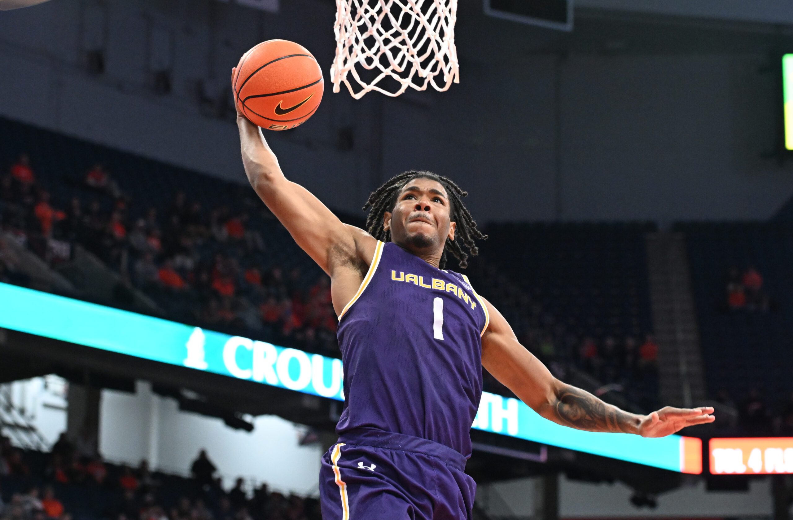Dec 10, 2024; Syracuse, New York, USA; Albany Great Danes guard Amar'e Marshall (1) dunks the ball against the Syracuse Orange in the first half at the JMA Wireless Dome. Mandatory Credit: Mark Konezny-Imagn Images