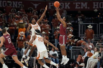 Dec 12, 2024; Austin, Texas, USA; nm New Mexico State Aggies guard Jaden Harris (13) shoots over Texas Longhorns guard Tramon Mark (12) during the second half at Moody Center. Mandatory Credit: Scott Wachter-Imagn Images