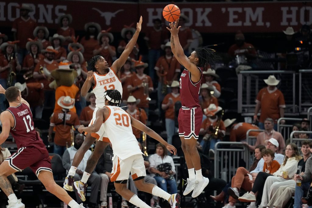 Dec 12, 2024; Austin, Texas, USA; nm New Mexico State Aggies guard Jaden Harris (13) shoots over Texas Longhorns guard Tramon Mark (12) during the second half at Moody Center. Mandatory Credit: Scott Wachter-Imagn Images