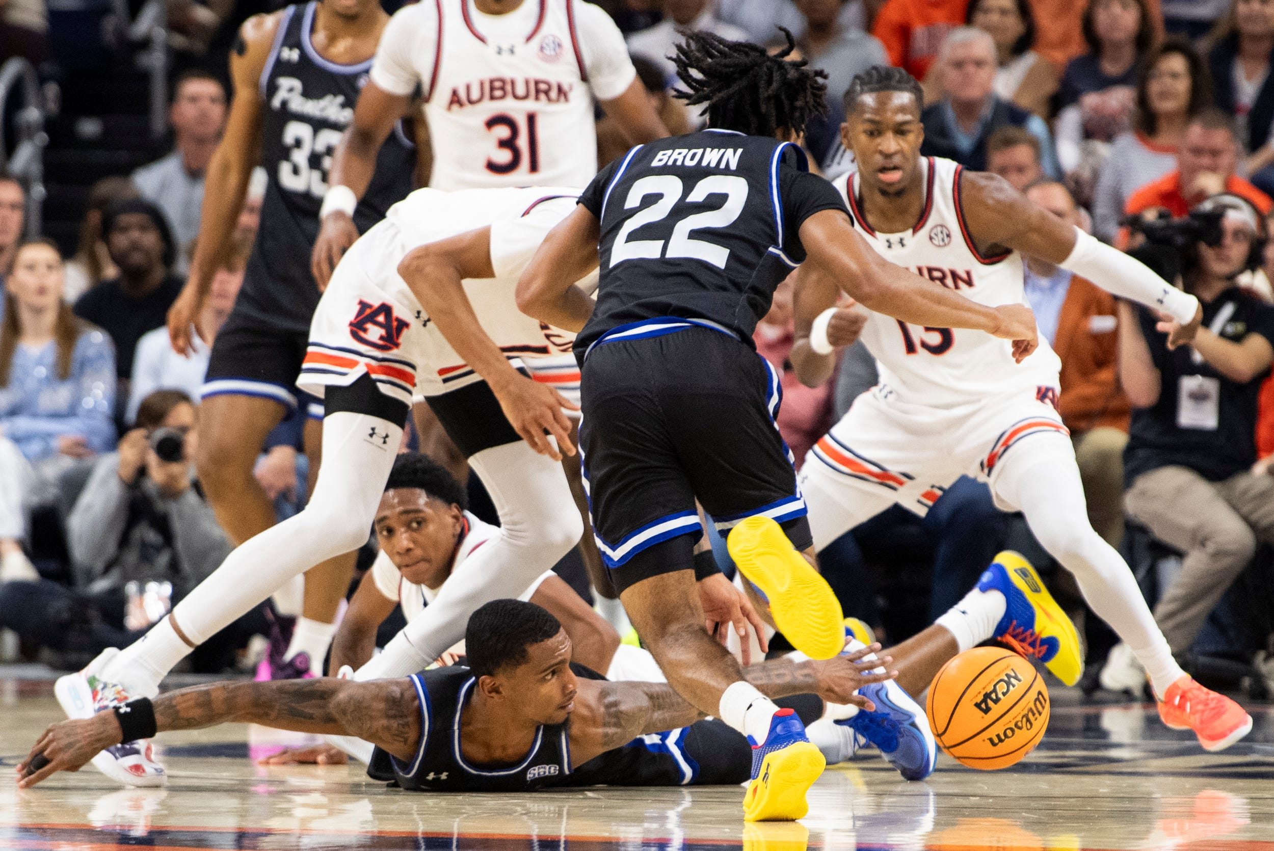 Georgia State Panthers guard Toneari Lane (11) dives for a loose ball as Auburn Tigers take on Georgia State Panthers at Neville Arena in Auburn, Ala., on Tuesday, Dec. 17, 2024. Auburn Tigers lead Georgia State Panthers 43-31 at halftime.