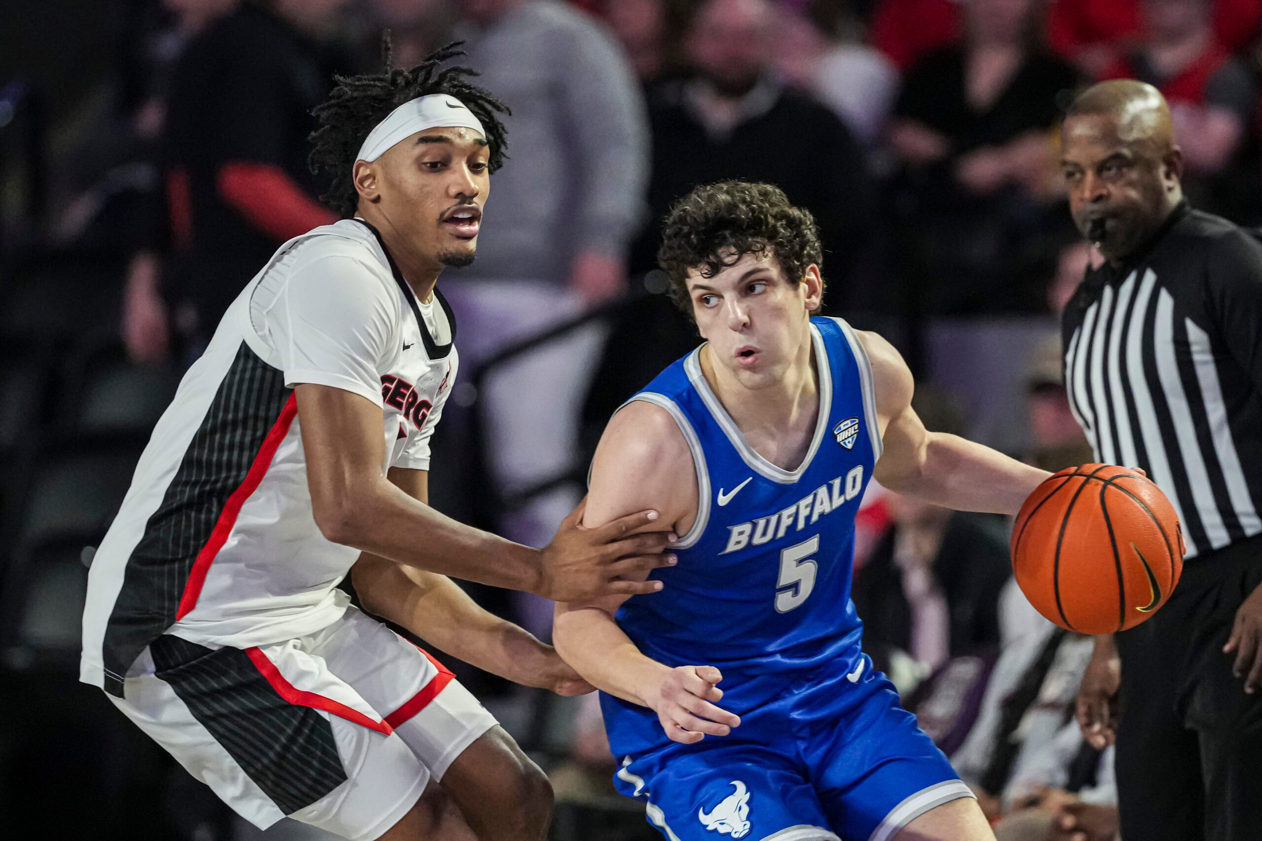 Dec 19, 2024; Athens, Georgia, USA; Georgia Bulldogs guard Tyrin Lawrence (7) defends against Buffalo Bulls guard Tyson Dunn (5) at Stegeman Coliseum. Mandatory Credit: Dale Zanine-Imagn Images