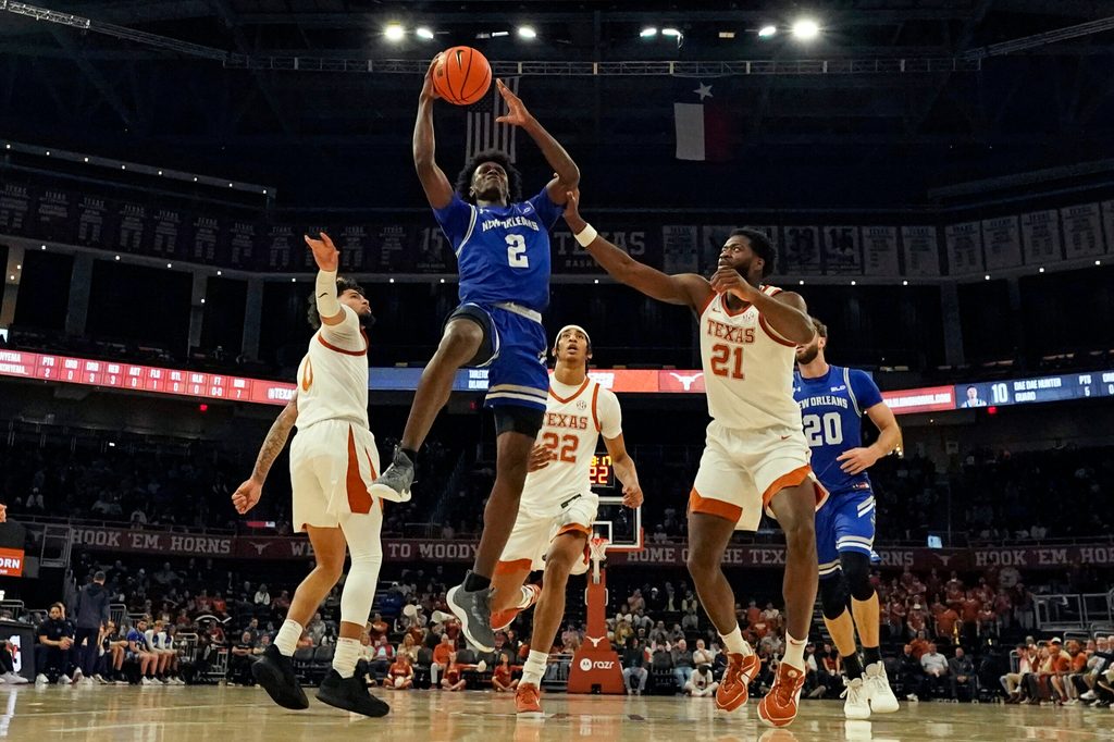 Dec 19, 2024; Austin, Texas, USA; New Orleans Privateers guard Jah Short (2) drives to the basket past Texas Longhorns guard Jordan Pope (0) and forward Ze'Rik Onyema (21) during the first half at Moody Center. Mandatory Credit: Scott Wachter-Imagn Images