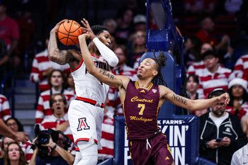 Dec 21, 2024; Tucson, Arizona, USA; Arizona Wildcats guard Caleb Love (1) rebounds the ball while Central Michigan Chippewas guard Damarion Bonds (7) attempts to knock the ball out of his hands during the second half of the game at McKale Center. Mandatory Credit: Aryanna Frank-Imagn Images