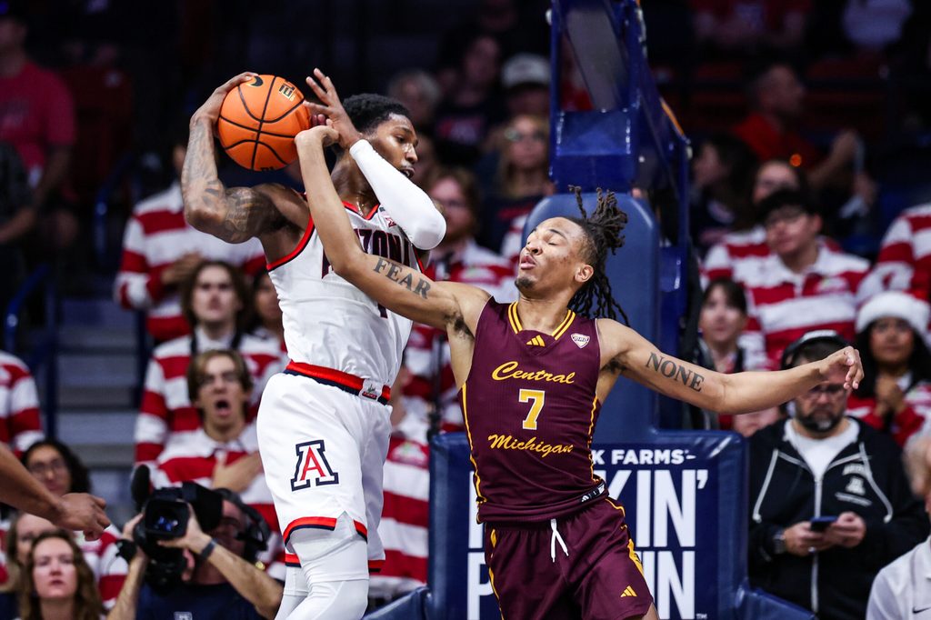 Dec 21, 2024; Tucson, Arizona, USA; Arizona Wildcats guard Caleb Love (1) rebounds the ball while Central Michigan Chippewas guard Damarion Bonds (7) attempts to knock the ball out of his hands during the second half of the game at McKale Center. Mandatory Credit: Aryanna Frank-Imagn Images
