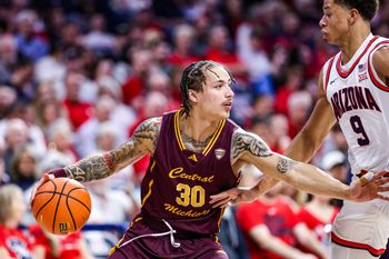 Dec 21, 2024; Tucson, Arizona, USA; Central Michigan Chippewas guard Anthony Pritchard (30) dribbles the ball while Arizona Wildcats forward Carter Bryant (9) attempts to block him during the second half of the game at McKale Center. Mandatory Credit: Aryanna Frank-Imagn Images