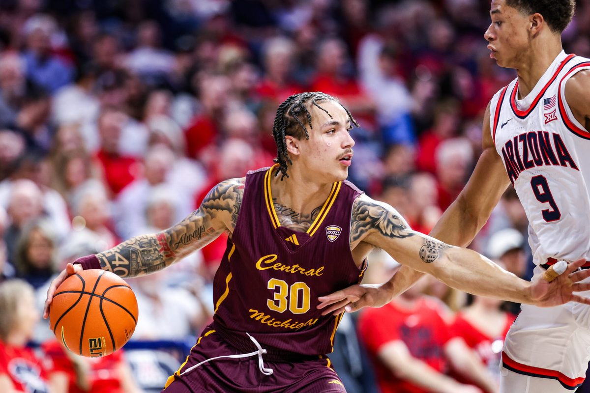 Dec 21, 2024; Tucson, Arizona, USA; Central Michigan Chippewas guard Anthony Pritchard (30) dribbles the ball while Arizona Wildcats forward Carter Bryant (9) attempts to block him during the second half of the game at McKale Center. Mandatory Credit: Aryanna Frank-Imagn Images