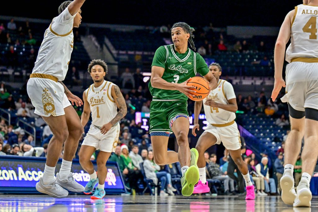 Dec 22, 2024; South Bend, Indiana, USA; Le Moyne Dolphins forward Dwayne Koroma (3) drives to the basket as Notre Dame Fighting Irish forward Tae Davis (7) defends in the second half at the Purcell Pavilion. Mandatory Credit: Matt Cashore-Imagn Images