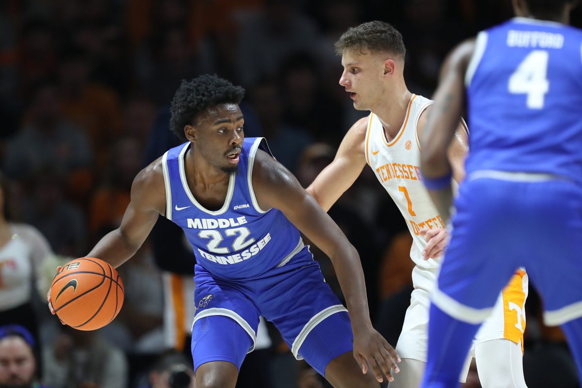 Dec 23, 2024; Knoxville, Tennessee, USA; Middle Tennessee Blue Raiders guard Kamari Lands (22) is defended by Tennessee Volunteers forward Igor Milicic Jr. (7) during the first half at Thompson-Boling Arena at Food City Center. Mandatory Credit: Randy Sartin-Imagn Images
