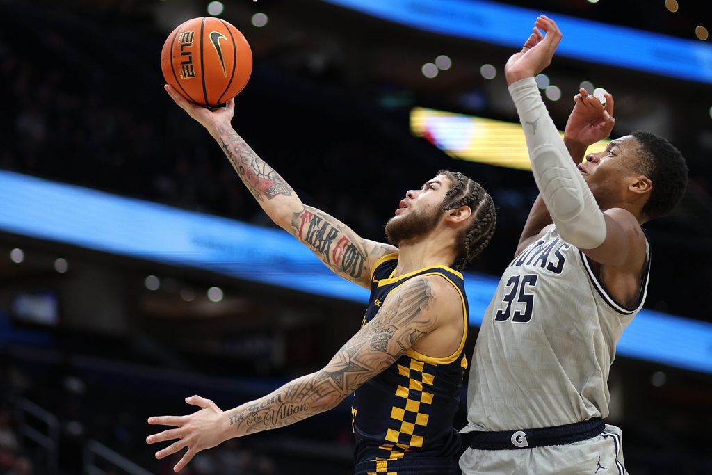 Dec 28, 2024; Washington, District of Columbia, USA; Coppin State Eagles forward Khali Horton (4) shoots the ball against Georgetown Hoyas forward Thomas Sorber (35) during the second half at Capital One Arena. Mandatory Credit: Daniel Kucin Jr.-Imagn Images