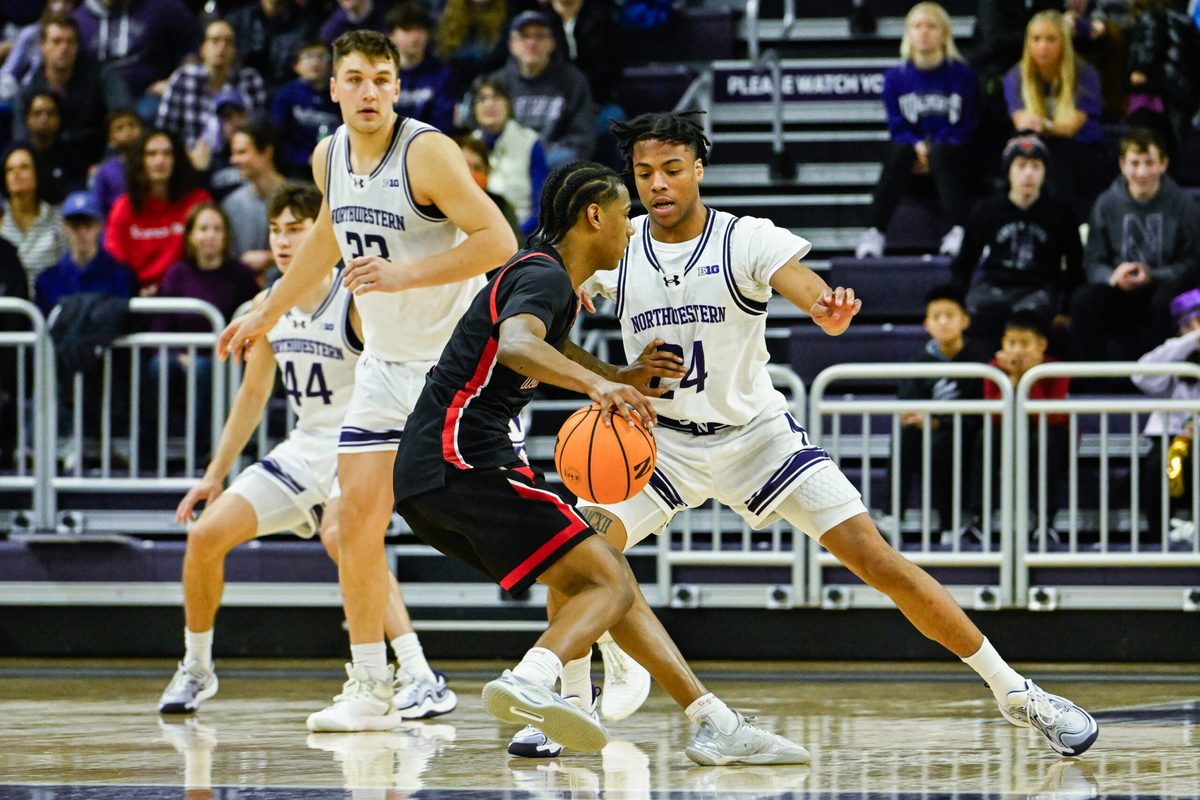 Dec 29, 2024; Evanston, Illinois, USA; Northeastern Huskies guard LA Pratt (3) moves the ball against Northwestern Wildcats guard K.J. Windham (24) during the second half at Welsh-Ryan Arena. Mandatory Credit: Matt Marton-Imagn Images