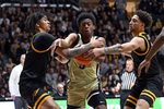 Dec 29, 2024; West Lafayette, Indiana, USA; Purdue Boilermakers guard Myles Colvin (5) pushes through Toledo Rockets guard Sonny Wilson (3), left, and guard Sam Lewis (11), right, during the second half at Mackey Arena. Mandatory Credit: Marc Lebryk-Imagn Images