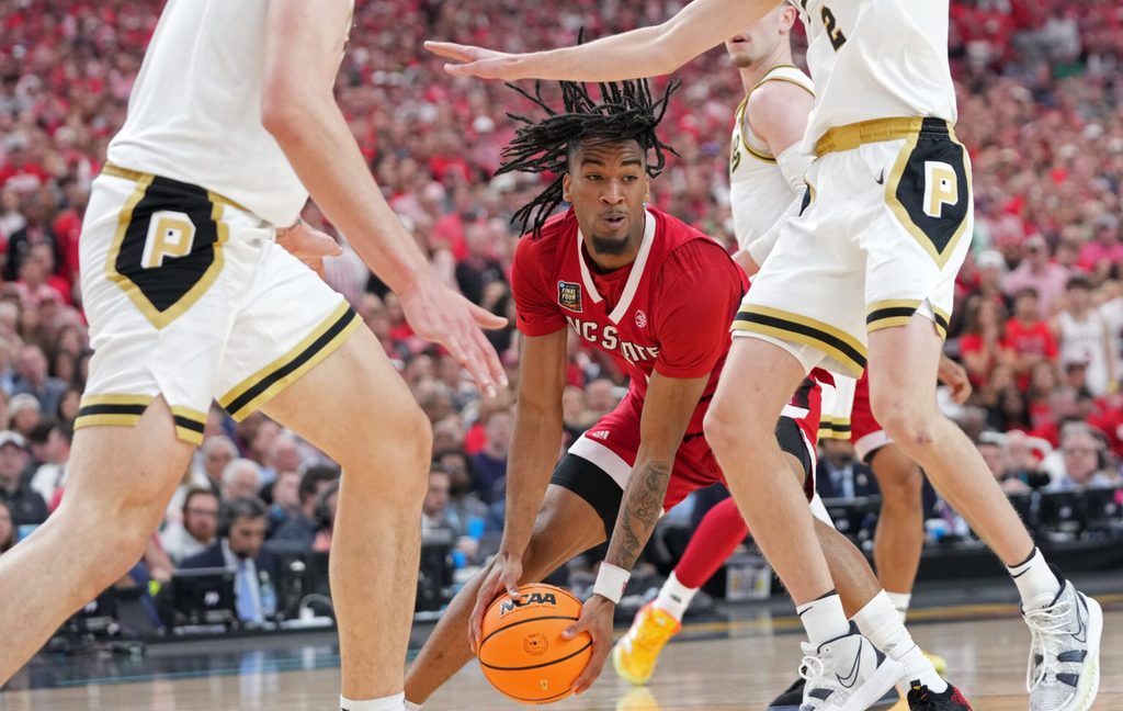 North Carolina State Wolfpack guard Jayden Taylor (1) drives into Purdue Boilermakers guard Fletcher Loyer (2) during the NCAA Men's Basketball Tournament Final Four game, Saturday, April 6, 2024, at State Farm Stadium in Glendale, Ariz.