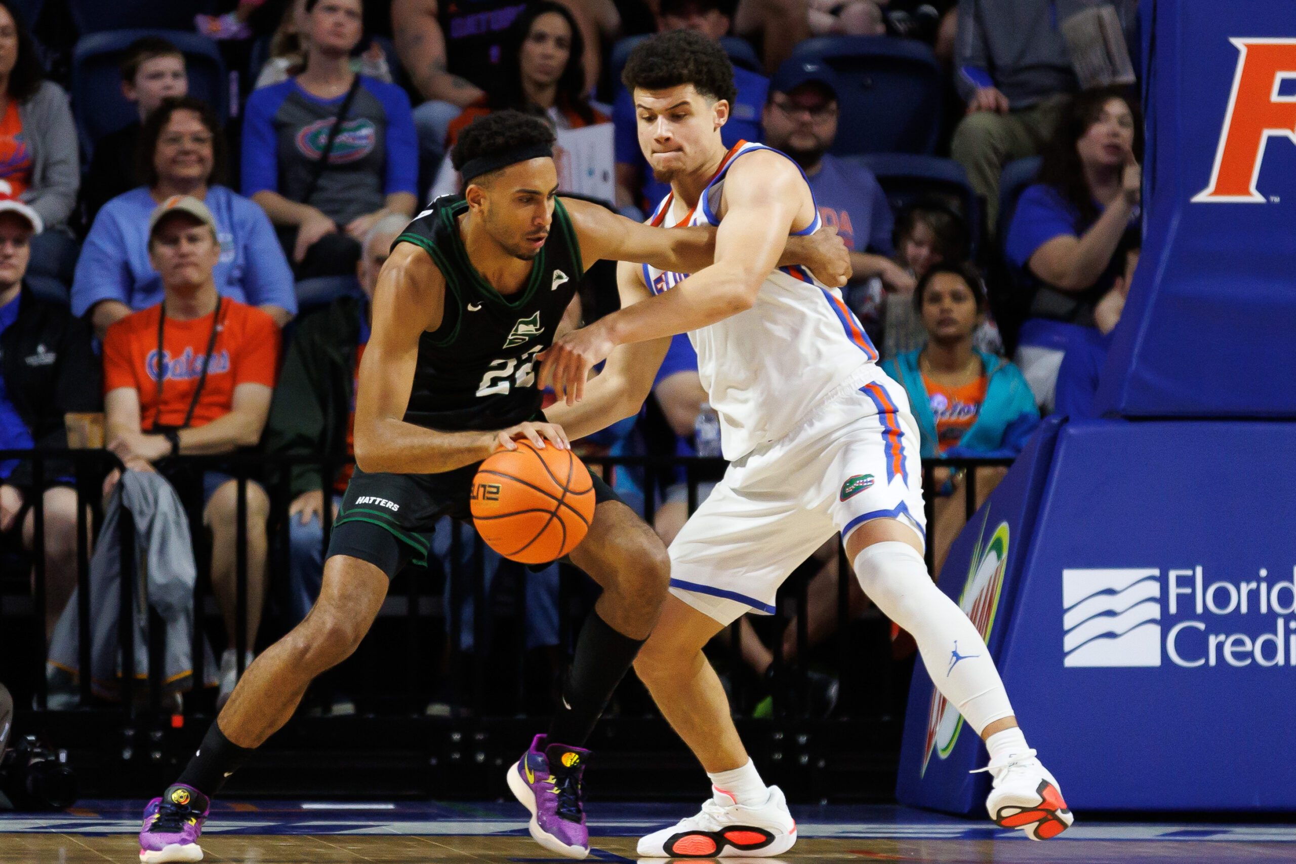 Dec 29, 2024; Gainesville, Florida, USA; Stetson Hatters guard Abramo Canka (22) posts up against Florida Gators guard Walter Clayton Jr. (1) during the second half at Exactech Arena at the Stephen C. O'Connell Center. Mandatory Credit: Matt Pendleton-Imagn Images